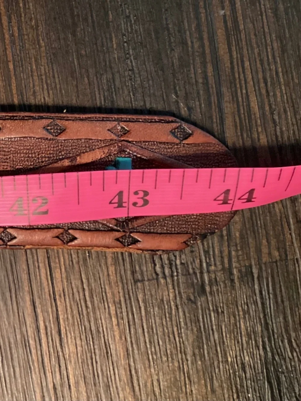Vintage Siskiyou Buckle Co. enameled belt buckle paired with tooled leather belt